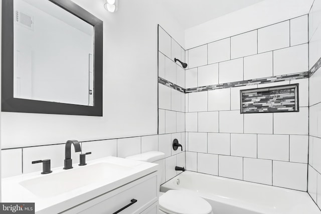 1330 Aisquith St, Baltimore, MD 21202 - full bathroom featuring toilet, tile walls, vanity, and shower / tub combination