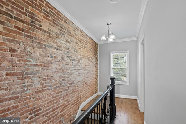 1330 Aisquith St, Baltimore, MD 21202 - corridor with ornamental molding, baseboards, a chandelier, hardwood / wood-style flooring, and brick wall