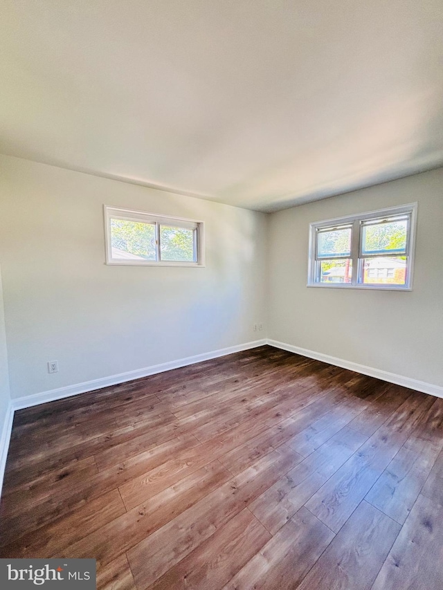 13015 Estelle Rd, Silver Spring, MD 20906 - unfurnished room featuring plenty of natural light, dark wood-type flooring, and baseboards