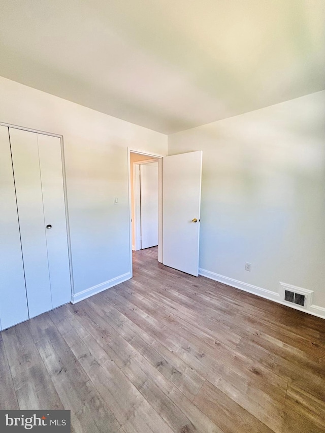 13015 Estelle Rd, Silver Spring, MD 20906 - unfurnished bedroom featuring wood finished floors, baseboards, and a closet