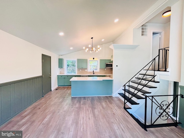 13015 Estelle Rd, Silver Spring, MD 20906 - kitchen featuring a chandelier, stainless steel microwave, a sink, light countertops, and tasteful backsplash