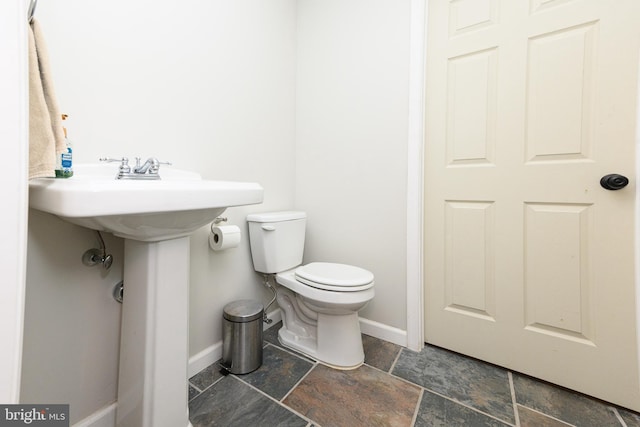 24 Furlong Rd, Douglassville, PA 19518 - bathroom featuring baseboards, toilet, stone finish flooring, and a sink