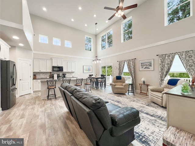 22543 Bradbury Way, Georgetown, DE 19947 - living room with a towering ceiling, a ceiling fan, light wood-type flooring, healthy amount of natural light, and recessed lighting