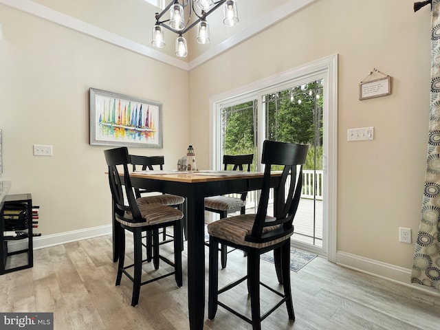 22543 Bradbury Way, Georgetown, DE 19947 - dining area featuring baseboards, light wood-style flooring, and a chandelier