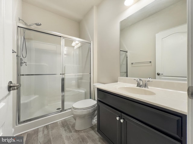22543 Bradbury Way, Georgetown, DE 19947 - full bathroom featuring wood finished floors, a shower stall, vanity, and toilet