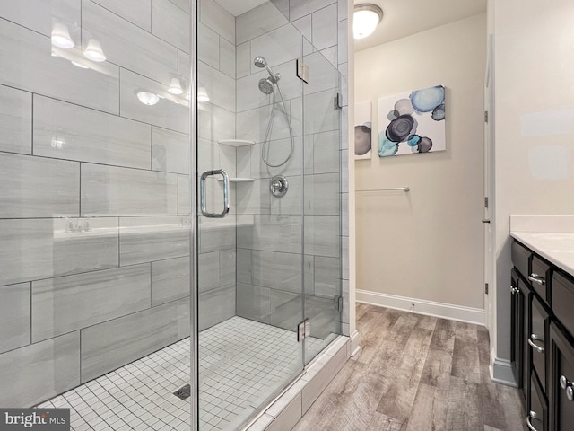 22543 Bradbury Way, Georgetown, DE 19947 - full bathroom featuring wood finished floors, vanity, a shower stall, and baseboards