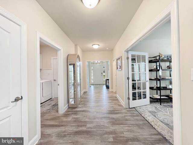 22543 Bradbury Way, Georgetown, DE 19947 - corridor featuring washer / dryer, wood finished floors, and baseboards