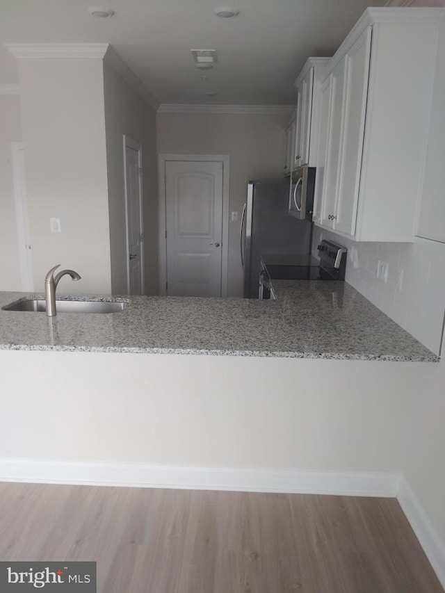 10019 Maids Fancy Way, Hagerstown, MD 21740 - kitchen with appliances with stainless steel finishes, a sink, light stone countertops, white cabinetry, and crown molding