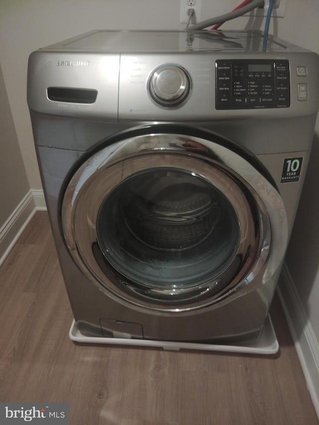 10019 Maids Fancy Way, Hagerstown, MD 21740 - washroom with washer / clothes dryer, wood finished floors, and baseboards