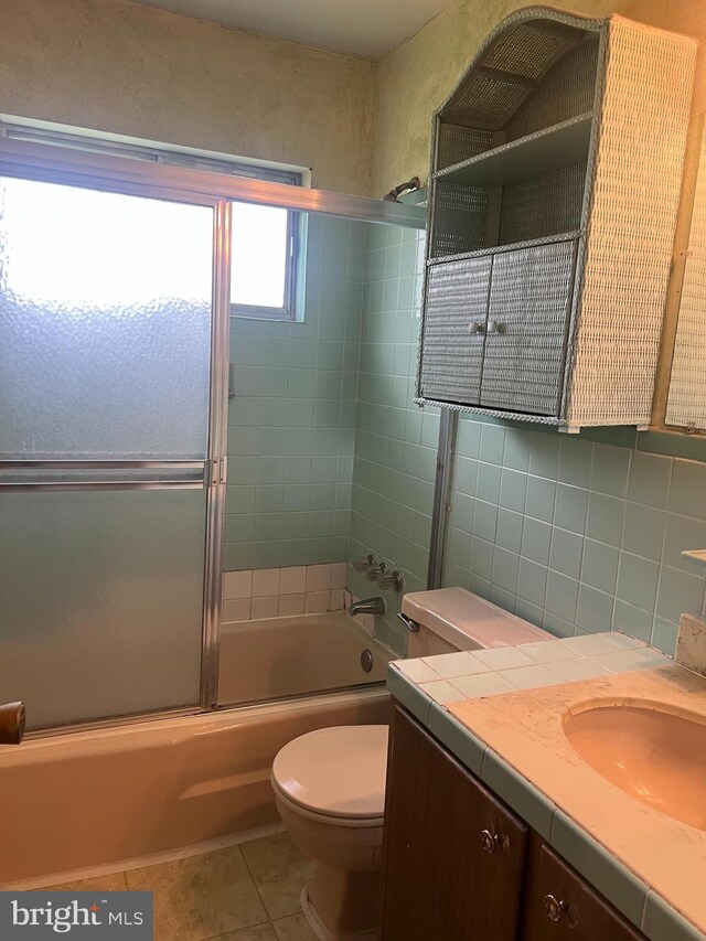 5933 Rawley Pike, Rockingham, VA 22801 - full bathroom featuring vanity, toilet, bath / shower combo with glass door, and tile patterned floors