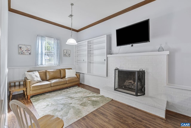 676 Victorian Ct, Charlottesville, VA 22901 - living area with wood finished floors, ornamental molding, a brick fireplace, and wainscoting
