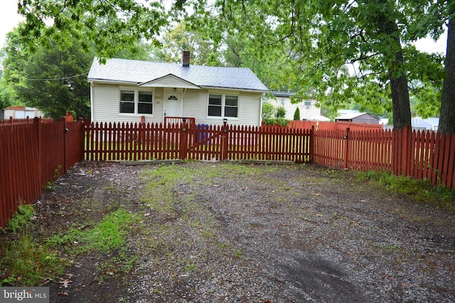 23 Foxglove St, Browns Mills, NJ 08015 - view of front of house with a fenced front yard and a chimney