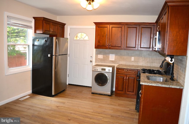 23 Foxglove St, Browns Mills, NJ 08015 - kitchen featuring washer / clothes dryer, stainless steel appliances, backsplash, and light wood finished floors