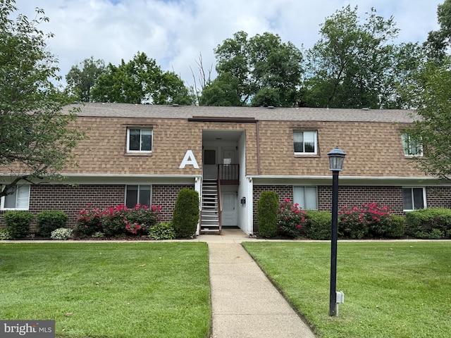 411 N Stiles Ave Unit A5, Maple Shade, NJ 08052 - view of front facade featuring roof with shingles, brick siding, a front yard, and mansard roof