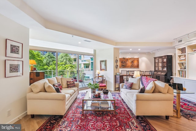 5610 Wisconsin Ave Unit 406, Chevy Chase, MD 20815 - living area featuring wood finished floors, rail lighting, and recessed lighting