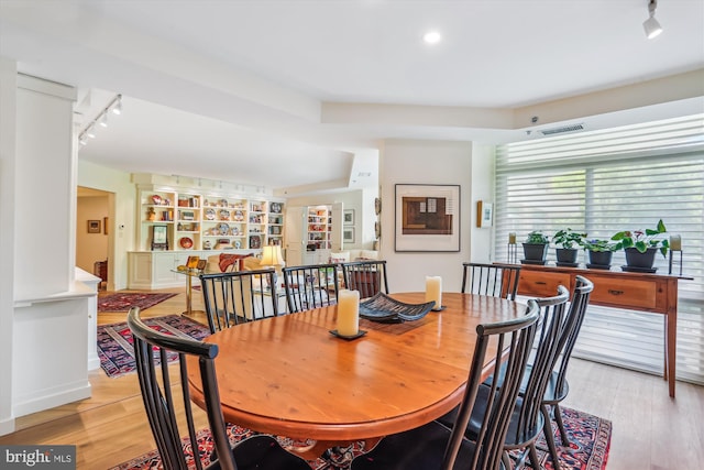 5610 Wisconsin Ave Unit 406, Chevy Chase, MD 20815 - dining area with track lighting, light wood finished floors, and built in features