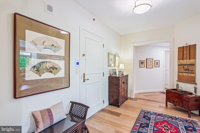 5610 Wisconsin Ave Unit 406, Chevy Chase, MD 20815 - foyer entrance with light wood-style flooring and baseboards