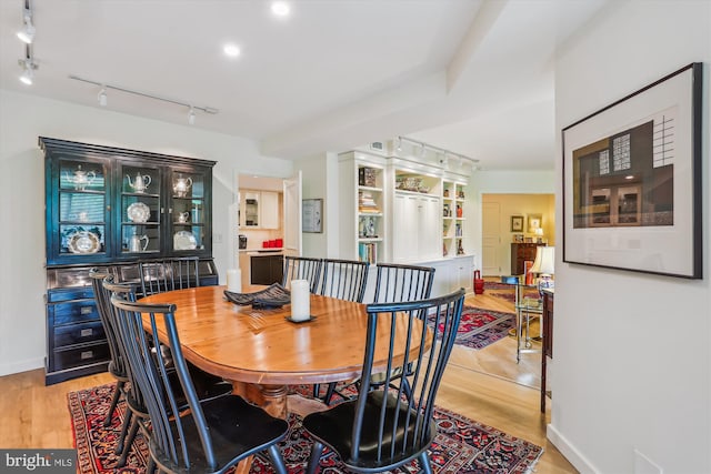 5610 Wisconsin Ave Unit 406, Chevy Chase, MD 20815 - dining space with light wood-style floors and track lighting