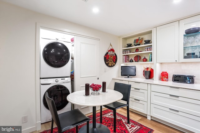 5610 Wisconsin Ave Unit 406, Chevy Chase, MD 20815 - dining area with stacked washer and clothes dryer, light wood-style floors, and built in shelves