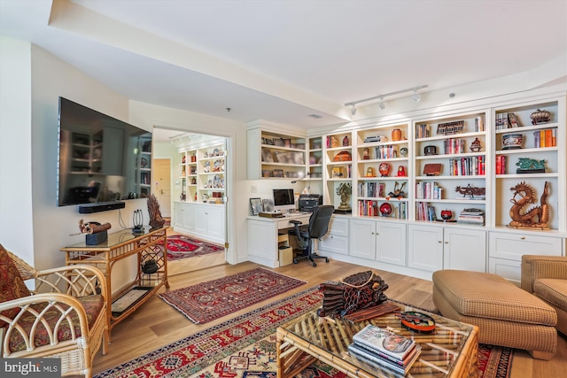 5610 Wisconsin Ave Unit 406, Chevy Chase, MD 20815 - office area featuring light wood finished floors, built in desk, and rail lighting