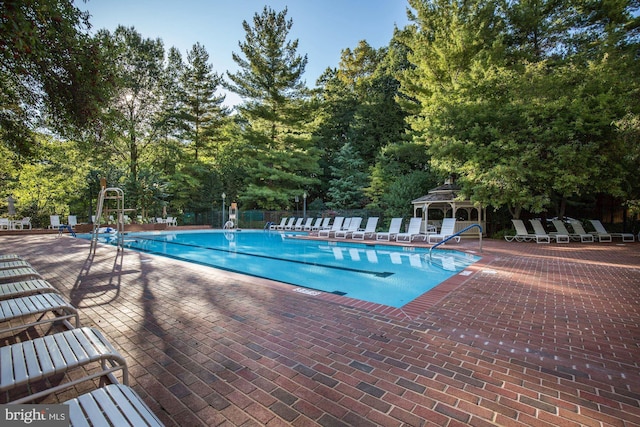 5610 Wisconsin Ave Unit 406, Chevy Chase, MD 20815 - community pool with a patio area, view of scattered trees, and a gazebo