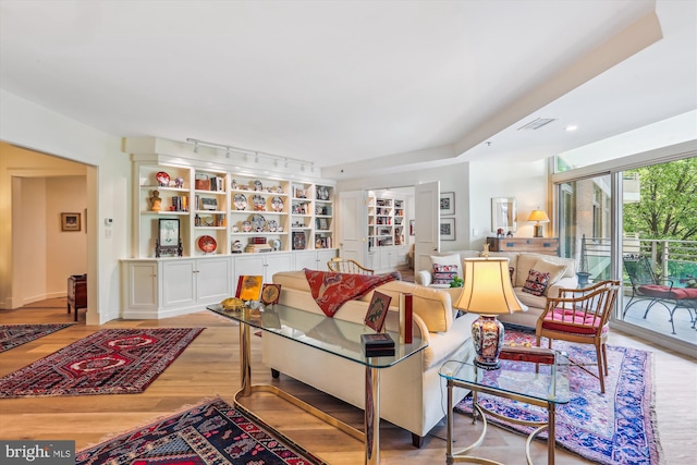 5610 Wisconsin Ave Unit 406, Chevy Chase, MD 20815 - living area featuring wood finished floors and rail lighting