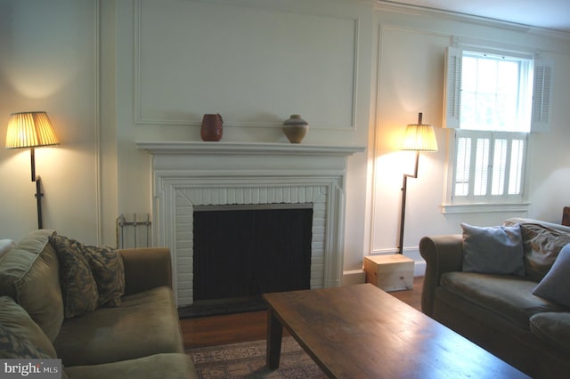 4305 Bradley Ln, Chevy Chase, MD 20815 - living room featuring a brick fireplace and wood finished floors