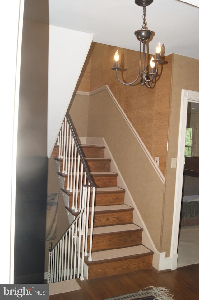 4305 Bradley Ln, Chevy Chase, MD 20815 - stairway with wood finished floors, a chandelier, and baseboards