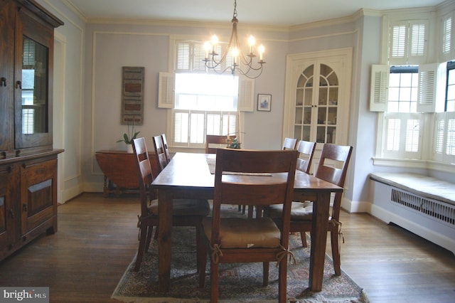 4305 Bradley Ln, Chevy Chase, MD 20815 - dining space featuring a chandelier, wood finished floors, radiator, baseboards, and crown molding