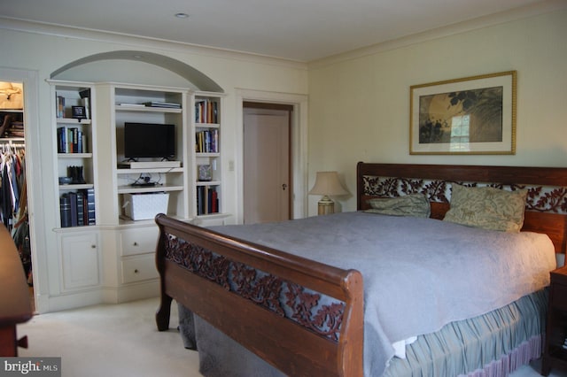 4305 Bradley Ln, Chevy Chase, MD 20815 - bedroom with ornamental molding, light colored carpet, a walk in closet, and a closet