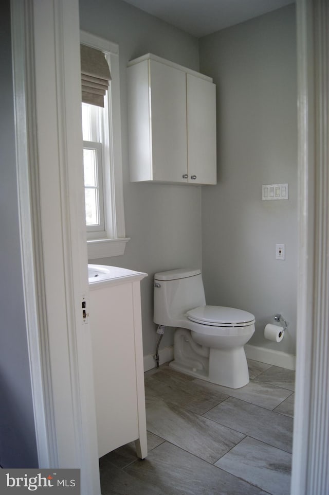 4305 Bradley Ln, Chevy Chase, MD 20815 - half bathroom featuring toilet, vanity, baseboards, and a bidet