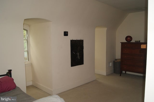 4305 Bradley Ln, Chevy Chase, MD 20815 - bedroom with arched walkways, carpet floors, baseboards, and vaulted ceiling