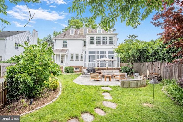 4305 Bradley Ln, Chevy Chase, MD 20815 - rear view of property featuring outdoor lounge area, a patio, stucco siding, and a sunroom