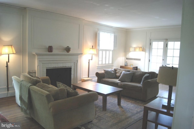 4305 Bradley Ln, Chevy Chase, MD 20815 - living area with healthy amount of natural light, ornamental molding, wood finished floors, a brick fireplace, and a decorative wall