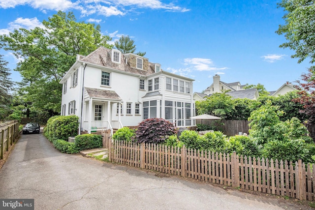 4305 Bradley Ln, Chevy Chase, MD 20815 - view of front facade with stucco siding and a sunroom