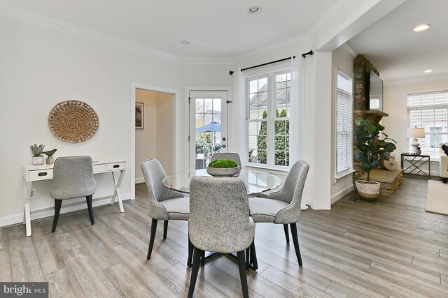 23219 Christopher Thomas Ln, Brambleton, VA 20148 - dining room featuring crown molding, healthy amount of natural light, light wood-style floors, and recessed lighting