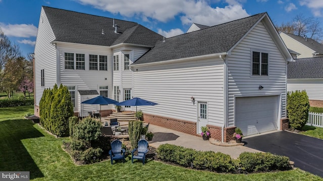 23219 Christopher Thomas Ln, Brambleton, VA 20148 - rear view of property with driveway, a lawn, brick siding, and roof with shingles