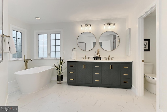 23219 Christopher Thomas Ln, Brambleton, VA 20148 - full bath with marble look tile flooring, double vanity, a soaking tub, and recessed lighting
