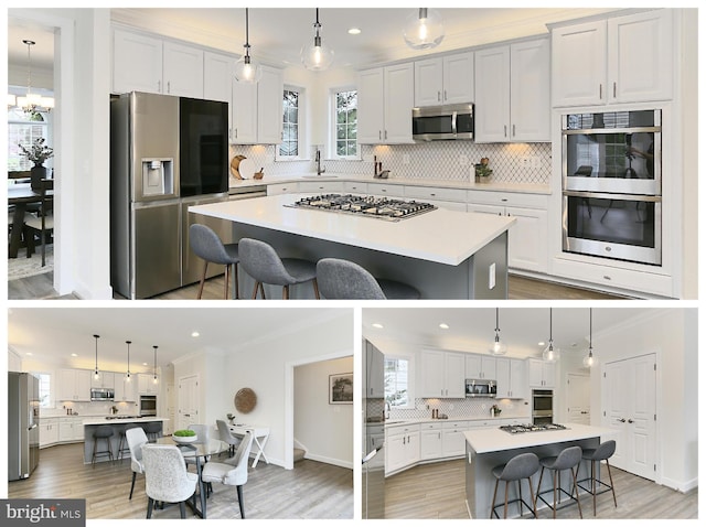 23219 Christopher Thomas Ln, Brambleton, VA 20148 - kitchen featuring appliances with stainless steel finishes, a spacious island, tasteful backsplash, crown molding, and a breakfast bar area