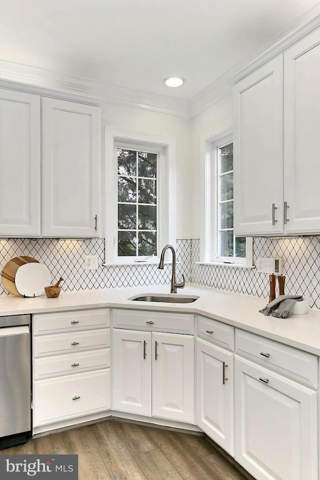 23219 Christopher Thomas Ln, Brambleton, VA 20148 - kitchen with white cabinetry, backsplash, light countertops, ornamental molding, and dishwasher