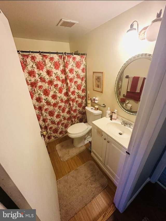 11529 Fenchurch Ct, Germantown, MD 20876 - full bathroom featuring wood finished floors, vanity, toilet, and a shower with curtain