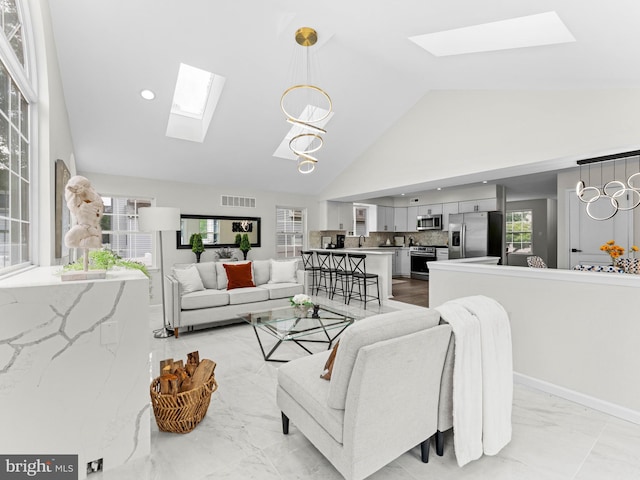 44 Wilson Dr, Sicklerville, NJ 08081 - living room featuring a skylight, high vaulted ceiling, plenty of natural light, and light marble finish floors