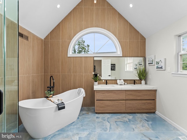 44 Wilson Dr, Sicklerville, NJ 08081 - full bathroom with vaulted ceiling, a freestanding tub, double vanity, marble look tiles, and baseboards
