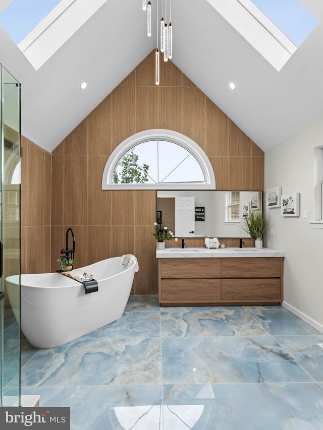 44 Wilson Dr, Sicklerville, NJ 08081 - full bathroom featuring a skylight, marble finish flooring, double vanity, lofted ceiling, and a soaking tub