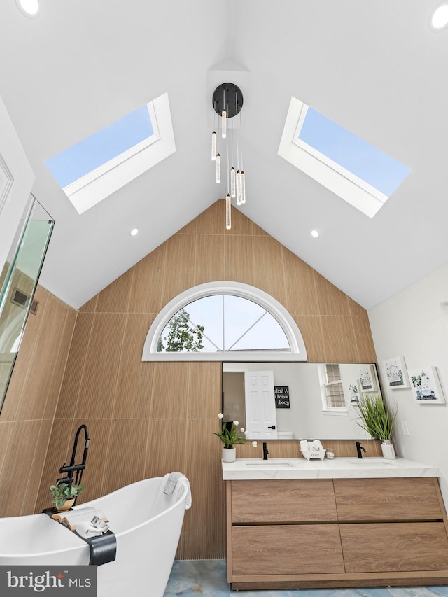 44 Wilson Dr, Sicklerville, NJ 08081 - bathroom with a skylight, a freestanding bath, double vanity, tile walls, and vaulted ceiling