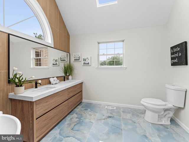 44 Wilson Dr, Sicklerville, NJ 08081 - bathroom featuring double vanity, vaulted ceiling, toilet, and baseboards
