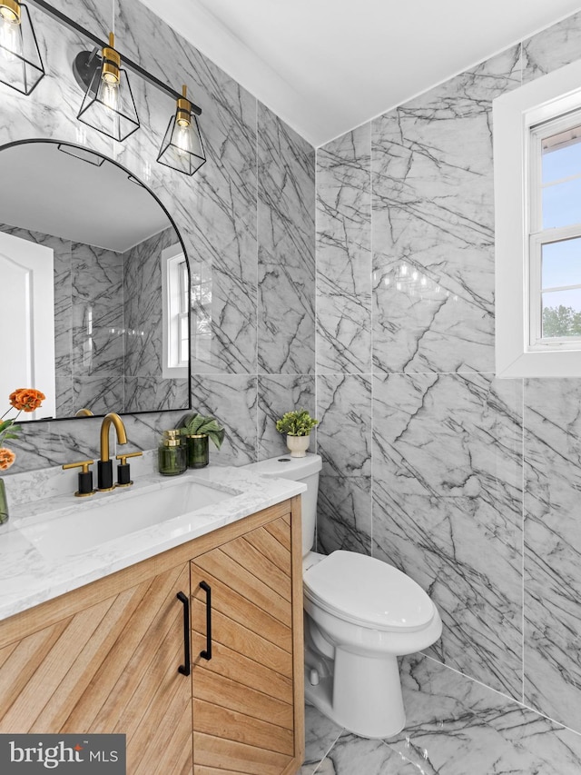 44 Wilson Dr, Sicklerville, NJ 08081 - bathroom featuring marble look tile flooring, tile walls, vanity, and toilet