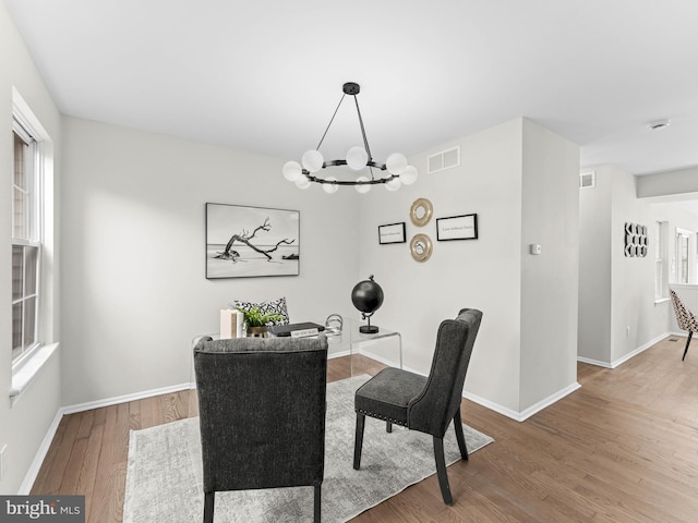 44 Wilson Dr, Sicklerville, NJ 08081 - dining space with wood finished floors, a chandelier, and baseboards
