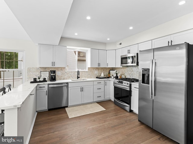 44 Wilson Dr, Sicklerville, NJ 08081 - kitchen featuring stainless steel appliances, a sink, a peninsula, decorative backsplash, and recessed lighting
