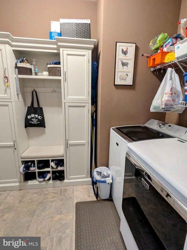35516 Hedgerow Ln, Rehoboth Beach, DE 19971 - laundry room featuring washer and clothes dryer and cabinet space